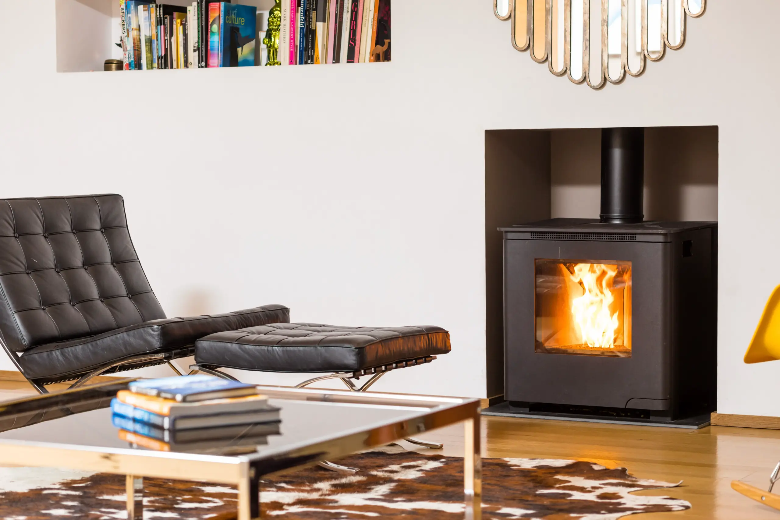 Modern pellet stove with visible flame in a stylish home interior.